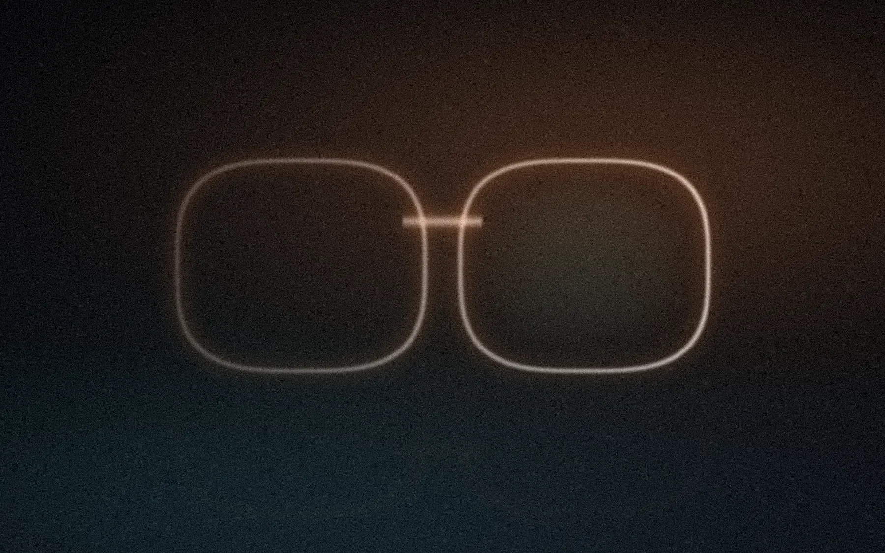 A thin lit pair of eyewear frames floating in a dark room, amber light from the upper right.